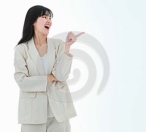 A young asian business woman has a big smile and place a finger close to her cheek, looking up to the side on copy space white