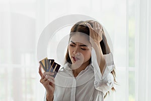 Young Asian business woman holding credit card with feeling unhappy, Financial problem concept