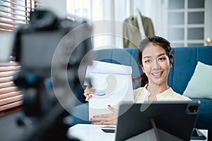 Young Asian business woman holding document meeting with team by video conference discuss online.