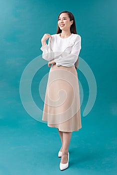 Young asian business woman isolated on blue background