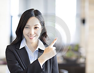 Young asian business woman pointing