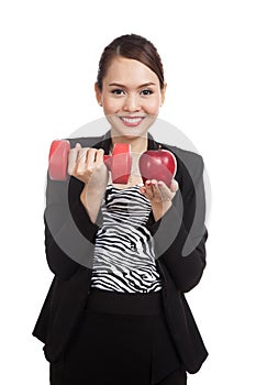 Young Asian business woman with red apple and dumbbells