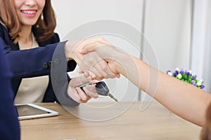 Young Asian business woman shaking hands with partners after finishing a meeting. Handshake greeting deal concept