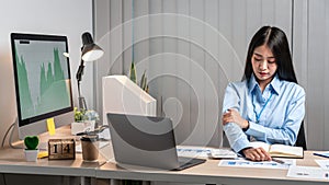 Young Asian Business woman sitting on the chair stretching herself and exercise for relaxation while working hard at office