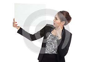 Young Asian business woman surprise with white blank sign