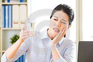 Young asian business woman with tooth sensitivity photo