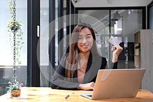 Young Asian business woman using smartphone and credit card for online shopping. Online Payment.