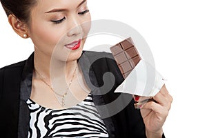 Young Asian business woman want to eat chocolate