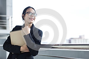 Young Asian business woman wear suit holding file document