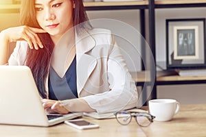 young Asian business woman at work. beautiful Asian woman in casual suit working with computer laptop in modern office. freelance