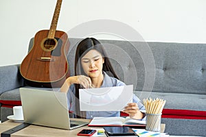 Young Asian business woman work from home using teleconference from notebook laptop.