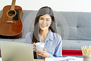 Young Asian business woman work from home using teleconference from notebook laptop.  social distancing new normal concept