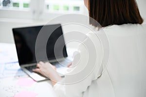 Young asian business woman working on computer laptop