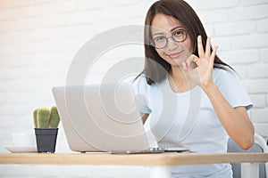 Young asian business woman working with laptop computer .