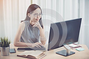 Young asian business woman working with computer .