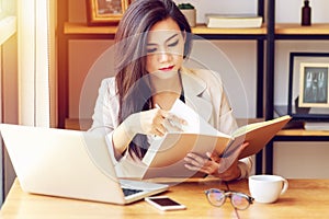 Young Asian business woman working at workplace.