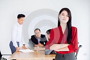 Young Asian business women leader executive standing confident working in office with team