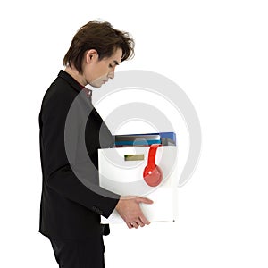 Young asian businessman in black suit feel sad, stressed and unhappy face holding paper box of belongings collected from office in