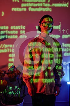 Young Asian businessman in casual clothes standing in openspace office