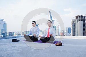 A Young asian Businessman doing sports at roof top