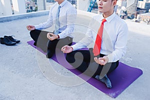 A Young asian Businessman doing sports at roof top