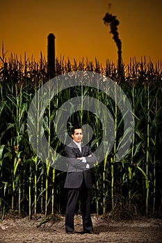 Young asian businessman in front of a corn field