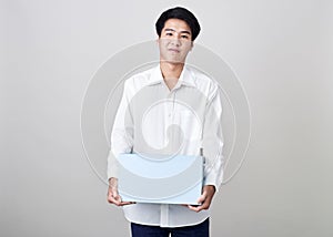 Young asian businessman holding a box