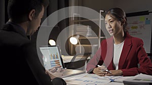 Young Asian businessman, man and woman working in office with laptop computers and financial documents.