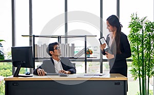 Young Asian businessman and a secretary in the office Together, work until completion