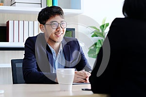 Young asian businessman smiling at business meeting, job interview, in office, business people, office lifestyle concept