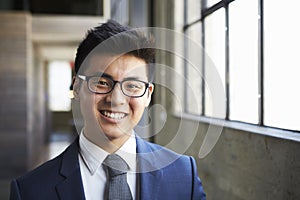 Young Asian businessman smiling to camera