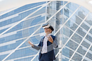 Young Asian businessman in a suit wear and virtual reality glass