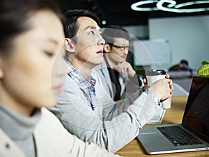 Young asian businessman thinking during meeting