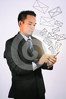 Young asian businessman touch his smartphone with Social Network Interface businessman icon