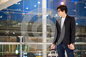 Young asian businessman waiting in airport terminal