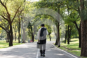 Young Asian businessman walking on the roads