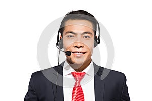 Young asian businessman wearing headset, studio shot.