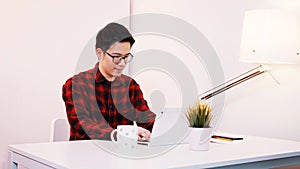 Young asian businessman working laptop at home