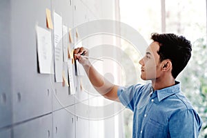 Young Asian Businessman Working in Office Meeting Room. Man Analysing Data Plans and Project