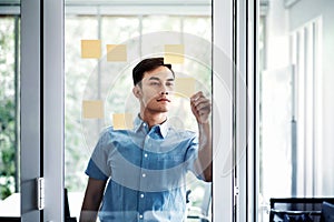 Young Asian Businessman Working in Office Meeting Room. Man Analyzing Data Plans and Project