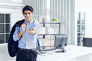 Young Asian Businessperson is standing smart poses and smile at co working space decorated in modern office style for startup