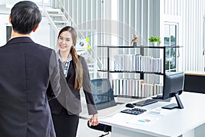 Young Asian Businessperson are standing and talking about financial business concept to agree on trade proposals within the modern