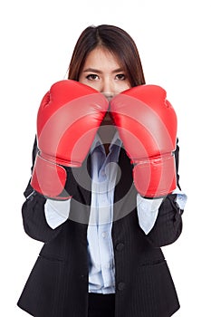 Young Asian businesswoman with boxing glove