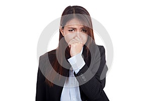 Young Asian businesswoman holding her nose because of a bad smell