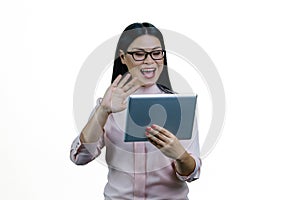 Young asian businesswoman is holding a tablet computer and waving her hand.