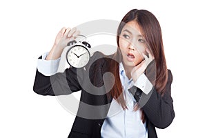 Young Asian businesswoman shock with alarm clock