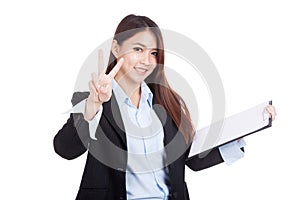 Young Asian businesswoman show victory sign with clipboard