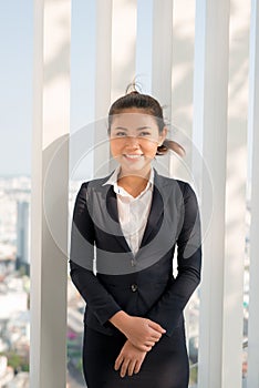 Young asian businesswoman in suit stading outside.