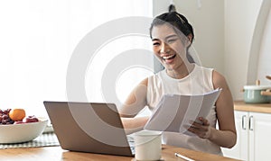 Young Asian businesswoman using computer laptop talking for video call conference meeting. work from home concept