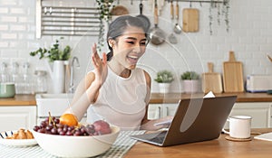 Young Asian businesswoman using computer laptop talking for video call conference meeting. work from home concept